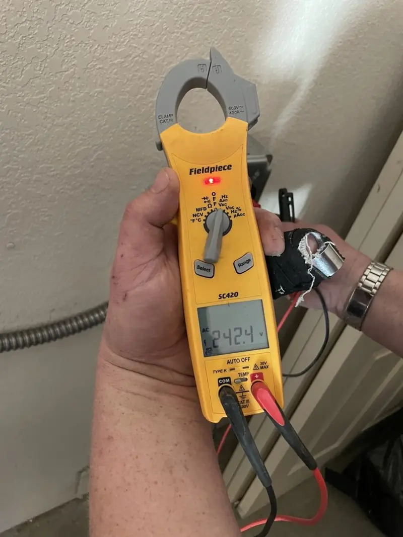 Voltage testing with clamp meter during Ceiling Fan Installation in Panama City Beach